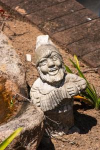 a statue of a gnome sitting on a rock at Sea Forever in Pennington