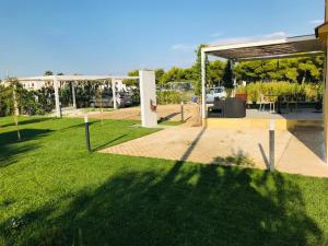 a backyard with a pavilion and a grass field at Maison Chopin & Brahms Haus in Vieste