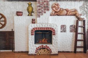 a brick fireplace with a monkey statue on top of it at Антиквар-отель мещанина Охлонина in Suzdal