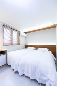 Postel nebo postele na pokoji v ubytování Hotel Gaon Seoul Dongdaemun