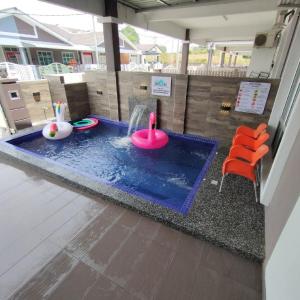 a miniature pool with a pink toy in a house at D'Q Putra Homestay Melaka (Unit AMAR) in Melaka