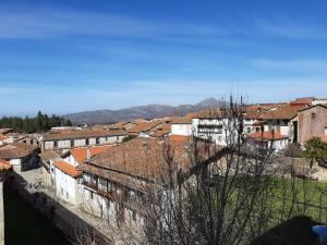 a view of a city with roofs and buildings at Apartamentos Candelario by gaiarooms in Candelario