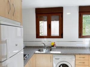 a kitchen with a sink and a washing machine at Apartamentos Candelario by gaiarooms in Candelario +66 photos