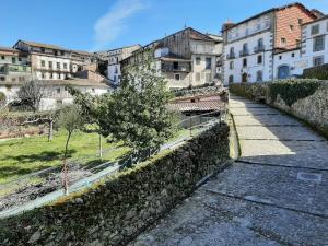 a street in a city with buildings and a tree at Apartamentos Candelario by gaiarooms in Candelario