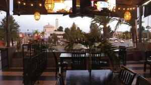 a restaurant with tables and chairs and a view of a city at Hotel Town Express in Durango