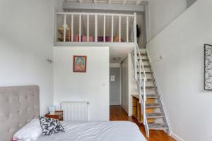 a bedroom with a bed and a stair case at Villa spacieuse à Bidart avec piscine privée 330 m² in Bidart +42 photos