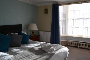 A bed or beds in a room at The Angel Posting House & Livery 