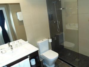 a bathroom with a shower and a toilet and a sink at Hotel Llorca in Platja de l’Almadrava