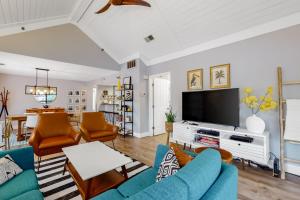 a living room with blue furniture and a flat screen tv at Centre Court 7832 in Hilton Head Island