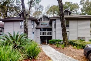 a white house with trees in front of it at Centre Court 7832 in Hilton Head Island