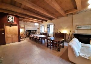 a large living room with tables and a couch at Le Clos de l'Atre in La Chaise-Dieu