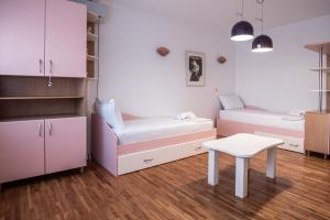 a small room with a couch and a table in it at Apartment Emilija in Skopje