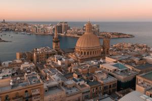 an aerial view of the city of dubrovnik at sunset at The Embassy Valletta Hotel in Valletta