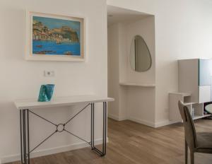 a living room with a table and a painting on the wall at La casa di Nausicaa: il mito dell'ospitalità in Reggio Calabria