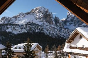 a mountain view from the balcony of a house in the snow at Garni Fany in Colfosco