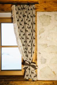 a curtain with bats on it next to a window at Garni Fany in Colfosco