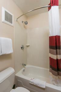 ein Bad mit einer Badewanne, einem WC und einer Dusche in der Unterkunft Red Roof Inn Marietta in Marietta