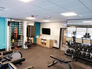 un gimnasio con equipo cardiovascular y TV en una habitación en Avid Hotels - Cincinnati N - West Chester, an IHG Hotel en West Chester