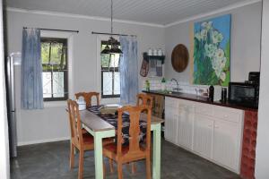 a kitchen with a table and chairs and a table and a counter at GABRIELLA'S in Riebeek-Kasteel