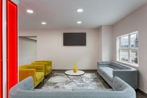 a living room with two couches and a tv at Super 8 by Wyndham San Antonio Airport North in San Antonio