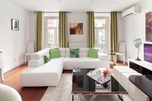 
a living room filled with furniture and a window at Lisbon Rentals Chiado in Lisbon
