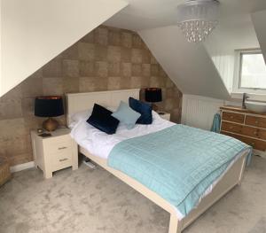 a bedroom with a bed with blue pillows on it at Blue Haven in Brighton & Hove