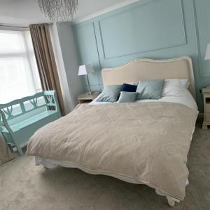 a bedroom with a large bed with blue walls at Blue Haven in Brighton & Hove