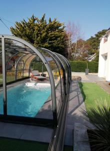 a swimming pool with a glass bridge over a swimming pool at Villa bord de mer avec piscine et jacuzzi in Pénestin