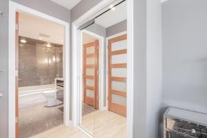 a bathroom with a toilet and a glass door at Eagle Lodge 225 by Outpost Whistler in Whistler +47 photos