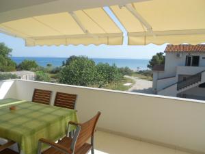 a balcony with a table and chairs and a view of the ocean at Apartment Niko in Vir