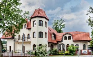 a large white house with a red roof at Willa Portowa - 120 metrów od plaży in Dziwnów