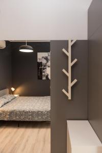 a bedroom with a bed and a black wall at The Chic Minimalist - apartment in Iaşi