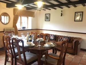 a dining room with a table and a couch at Wensum House in Norwich