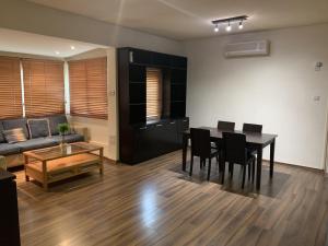 a living room with a table and chairs and a couch at Kika Court 2 in Paralimni
