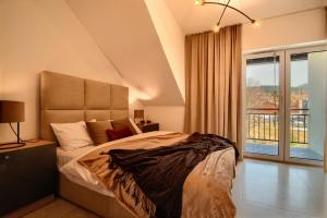 Posteľ alebo postele v izbe v ubytovaní Apartament Royal Szczyrk