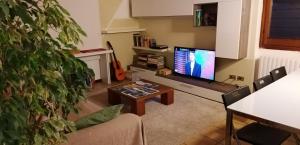 a living room with a television and a table at Casa Avezza in Omegna +18 photos