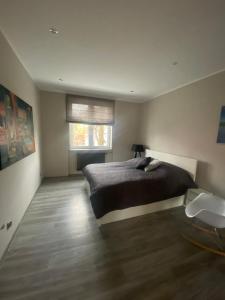 a bedroom with a large bed and a window at Apartament Centrum- Art&Design in Konin