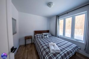 Кровать или кровати в номере Chalet le Caribou- Chalets Galaxia