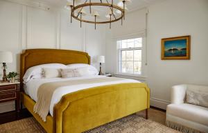 a bedroom with a large bed and a large window at Kennebunkport Captains Collection in Kennebunkport