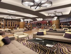 a library with couches and chairs in a room at Surmeli Istanbul Hotel in Istanbul