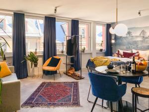 a living room with a couch and a table and chairs at Astoria Apartments in Nürnberg