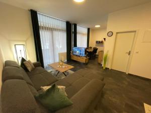 a living room with a couch and a table at Mariposa 4 incl Pool & Sauna in Bad Harzburg