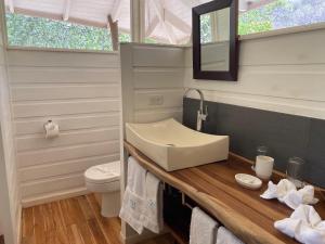 a bathroom with a sink and a toilet at Mikado Natural Lodge in Playa Avellana