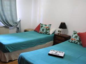 two beds in a room with a sign on top of them at Belvilla by OYO Hacienda Lugar de Sinde in Val