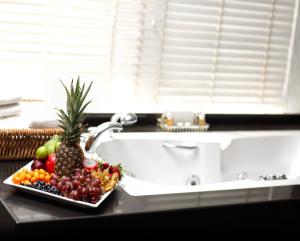 a plate of fruit on a counter next to a sink at Surmeli Istanbul Hotel in Istanbul