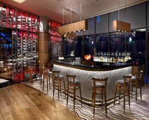 a bar in a restaurant with bar stools at Surmeli Istanbul Hotel in Istanbul