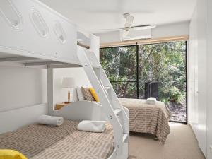 A bed or beds in a room at Charming Avoca Beach Home with Sublime Outdoor Space