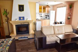 a living room with a couch and a fireplace at Apartment Naberezhnaya 20 in Petropavlovsk-Kamchatskiy