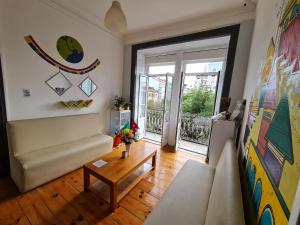 a living room with a couch and a table at Shangri-La Hostel Anjos in Lisbon