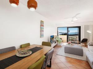 a dining room and living room with a table at Beachfront Terrigal - 4/24 Terrigal Espl in Terrigal